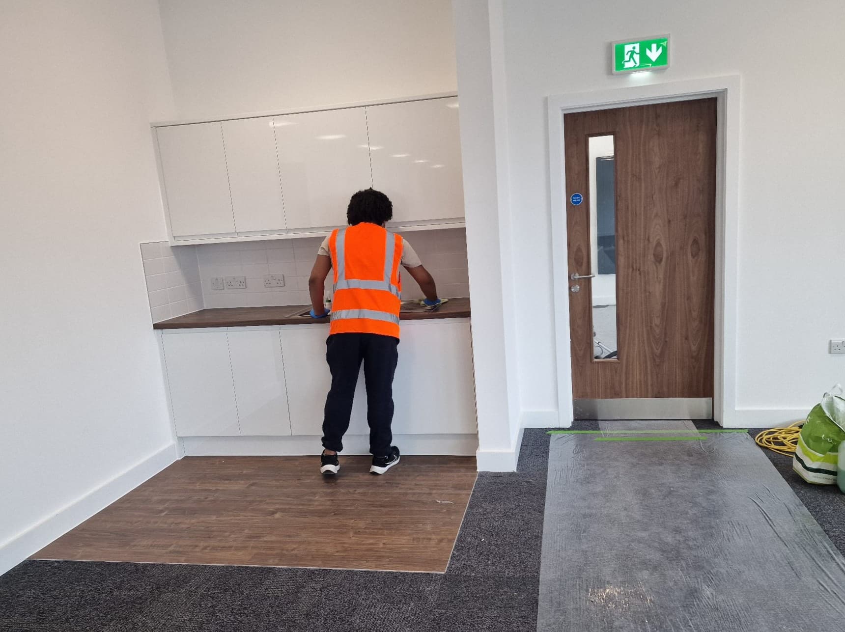 Luna Cleaning Solutions operative vacuuming an office carpet